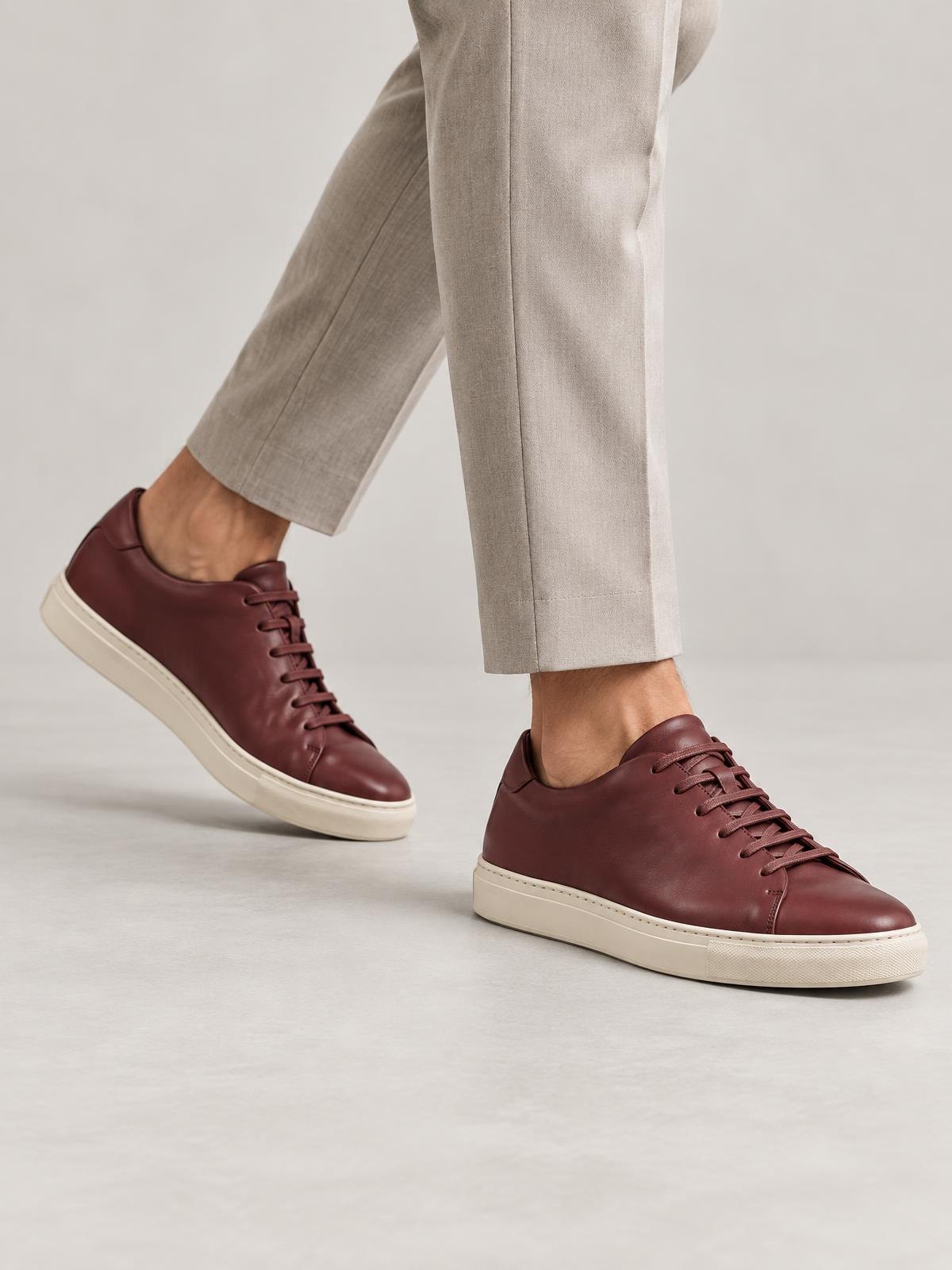 Kestrel Form Leather Court Sneaker in burgundy — worn by a model