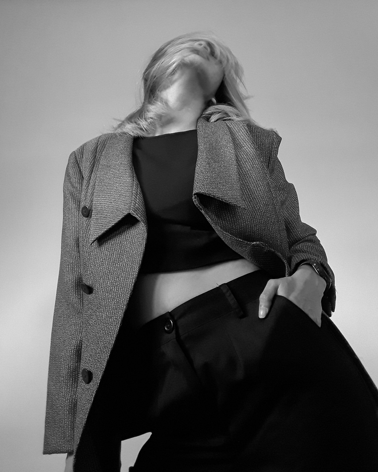 Black and white portrait of a model in an oversized houndstooth blazer